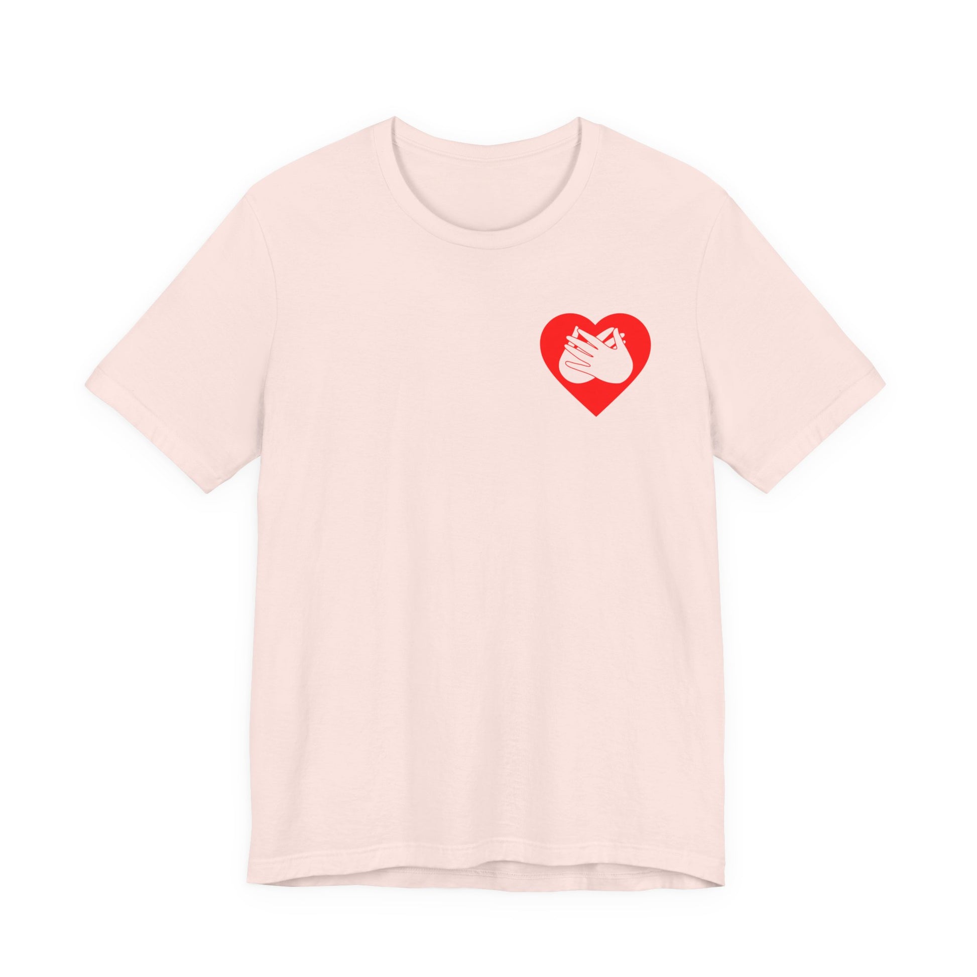 Front view of a soft pink T-Shirt showing a red coloured heart and the iconic BSL Love sign embedded in it on the left side of the chest