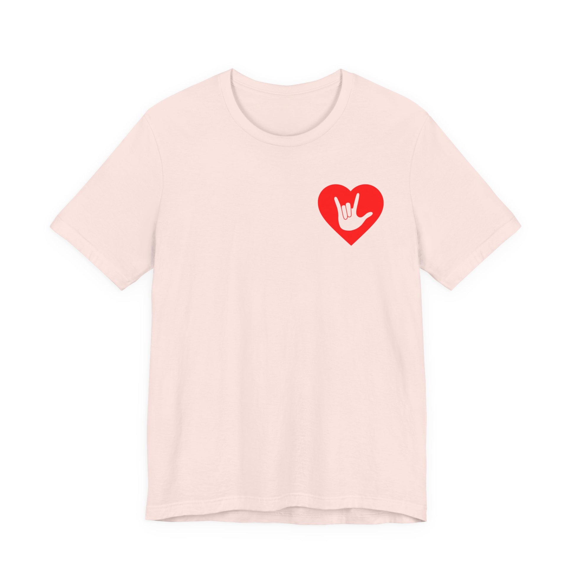 Front view of a soft pink T-Shirt showing a red coloured heart and the iconic ASL I Love You sign embedded in it on the left side of the chest