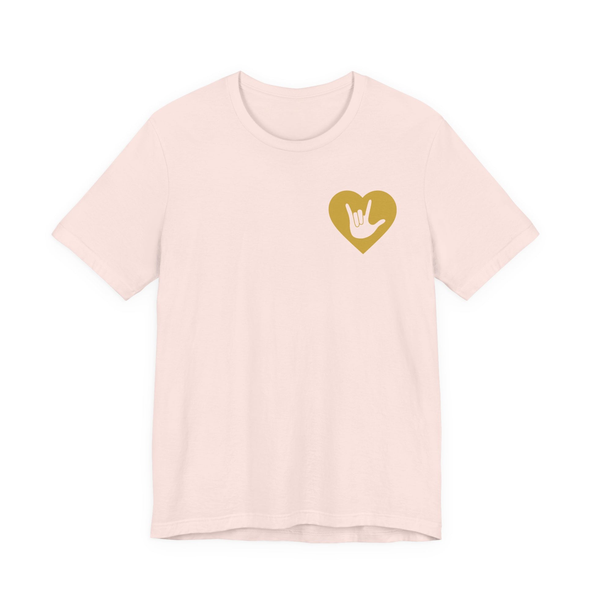 Front view of a soft pink T-Shirt showing a gold coloured heart and the iconic ASL I Love You sign embedded in it on the left side of the chest