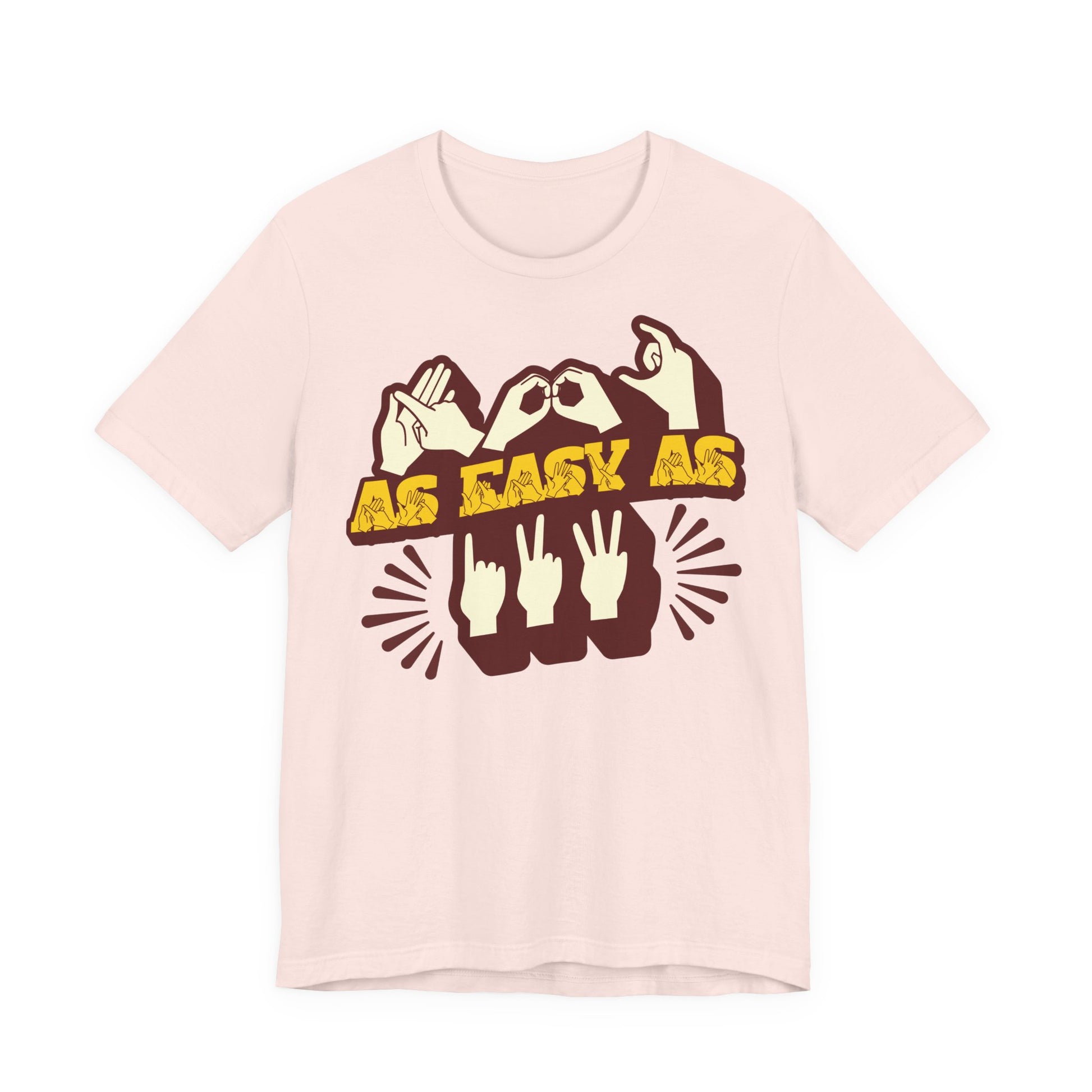 Front view of a soft pink t-shirt with the phrase ABC As Easy As 123 in Fingerspelling & Text