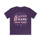 Purple kids' t-shirt with the phrase "Birthday Girl" in colourful text, a party hat on the letter B, stars surrounding the phrase, and a customisable name section below.