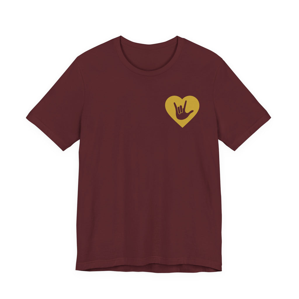 Front view of a maroon T-Shirt showing a gold coloured heart and the iconic ASL I Love You sign embedded in it on the left side of the chest