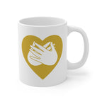 White mug with a gold coloured heart design featuring the BSL sign for Love embedded in it. The mug handle is on the right hand side of the mug.