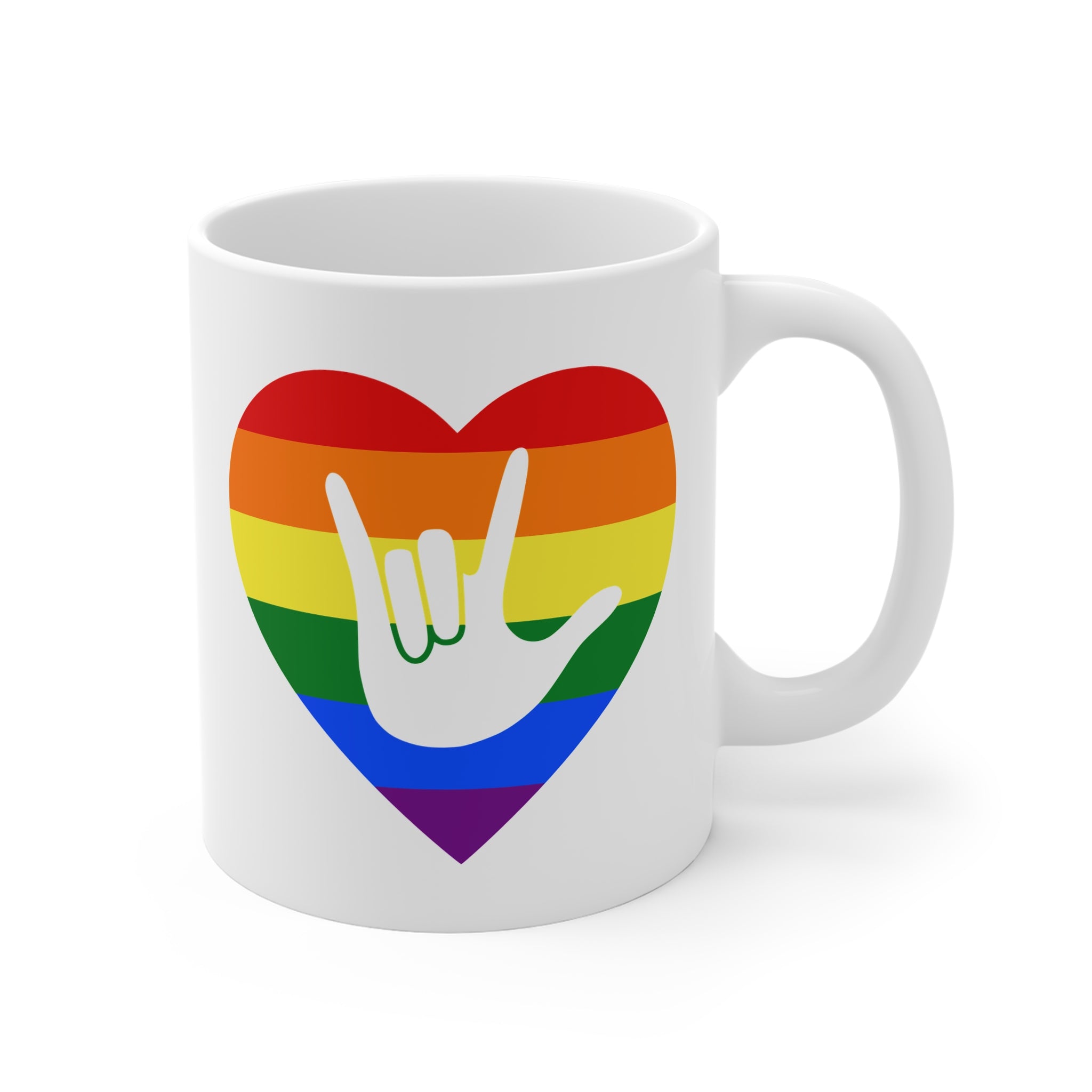 White mug with a rainbow heart design featuring the ASL sign for I Love You embedded in it. The mug handle is on the right hand side of the mug.