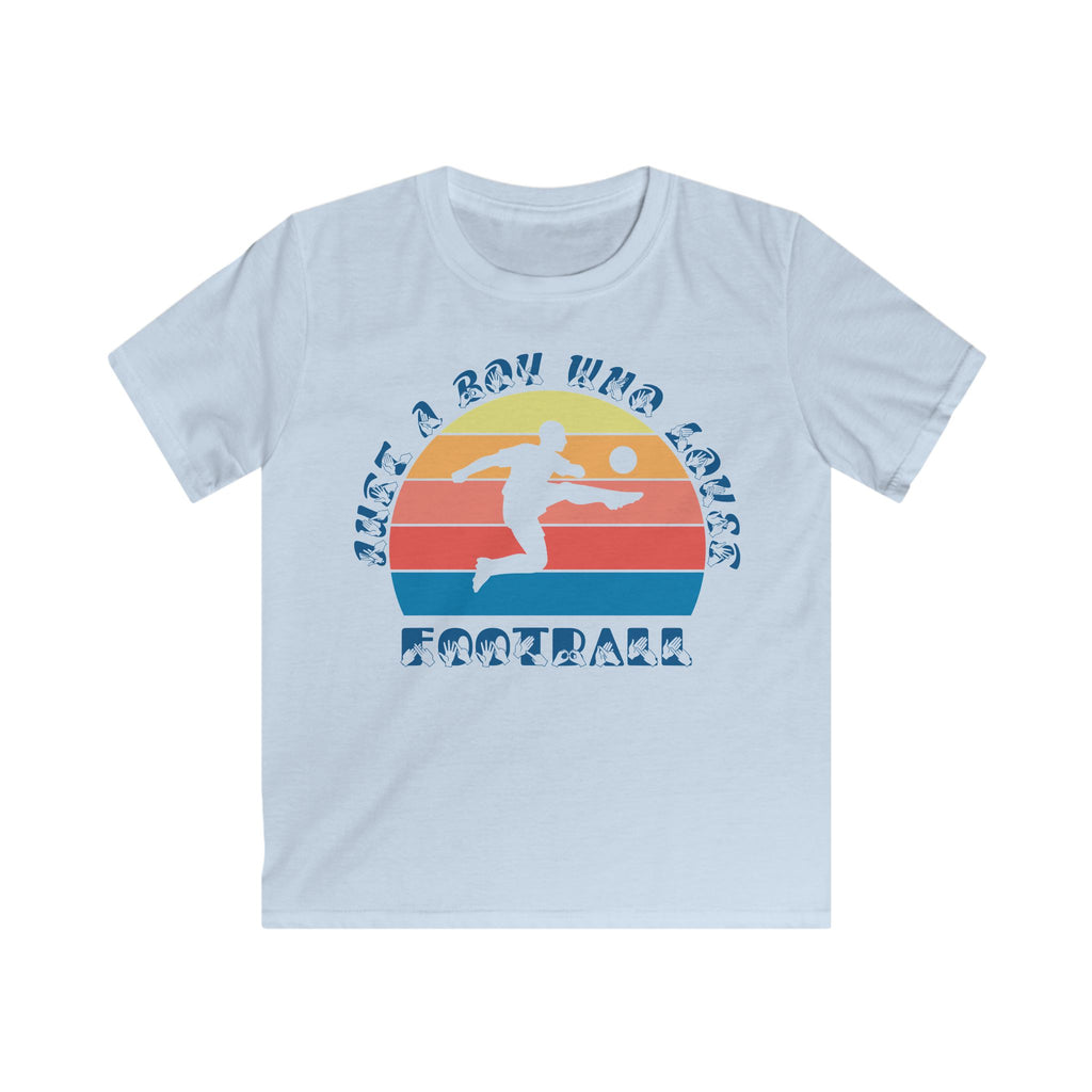 Light blue t-shirt with the phrase "Just a Boy Who Loves Football" in BSL Fingerspelling and text featuring a colourful retro sunset and a silhouette of a boy kicking a football.