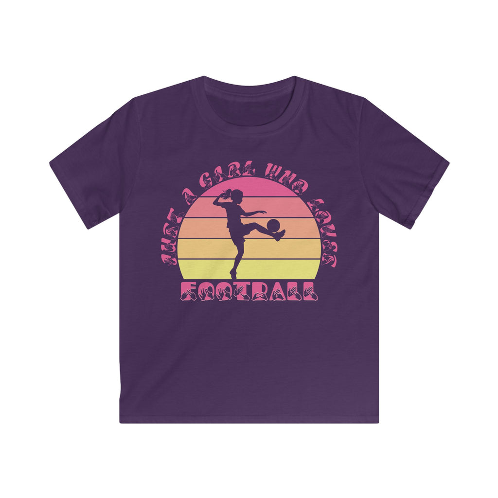 Purple t-shirt with the phrase "Just a Girl Who Loves Football" in BSL Fingerspelling and text featuring a colourful retro sunset and a silhouette of a boy kicking a football.
