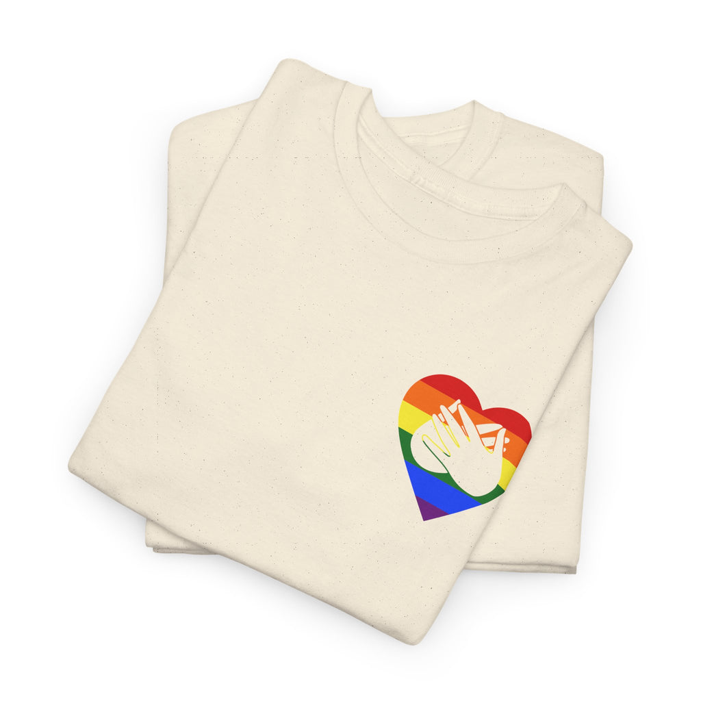 Folded natural T-Shirt showing a pride coloured heart and the iconic BSL Love sign embedded in it on the left side of the chest