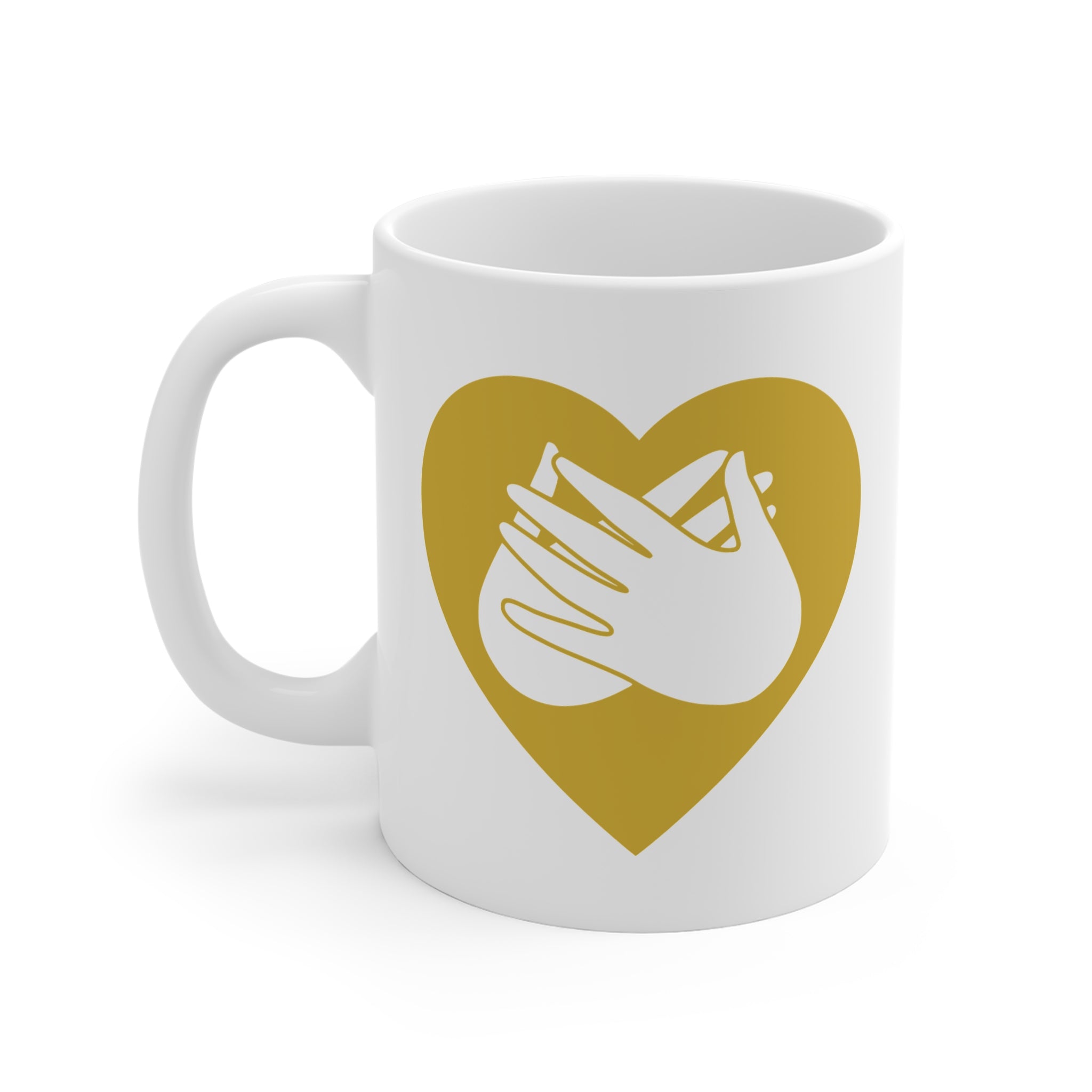 White mug with a gold coloured heart design featuring the BSL sign for Love embedded in it. The mug handle is on the left hand side of the mug.