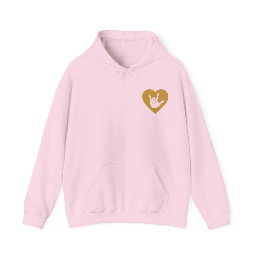 Front view of a light pink hoodie showing a gold coloured heart and the iconic ASL I Love You sign embedded in it on the left side of the chest