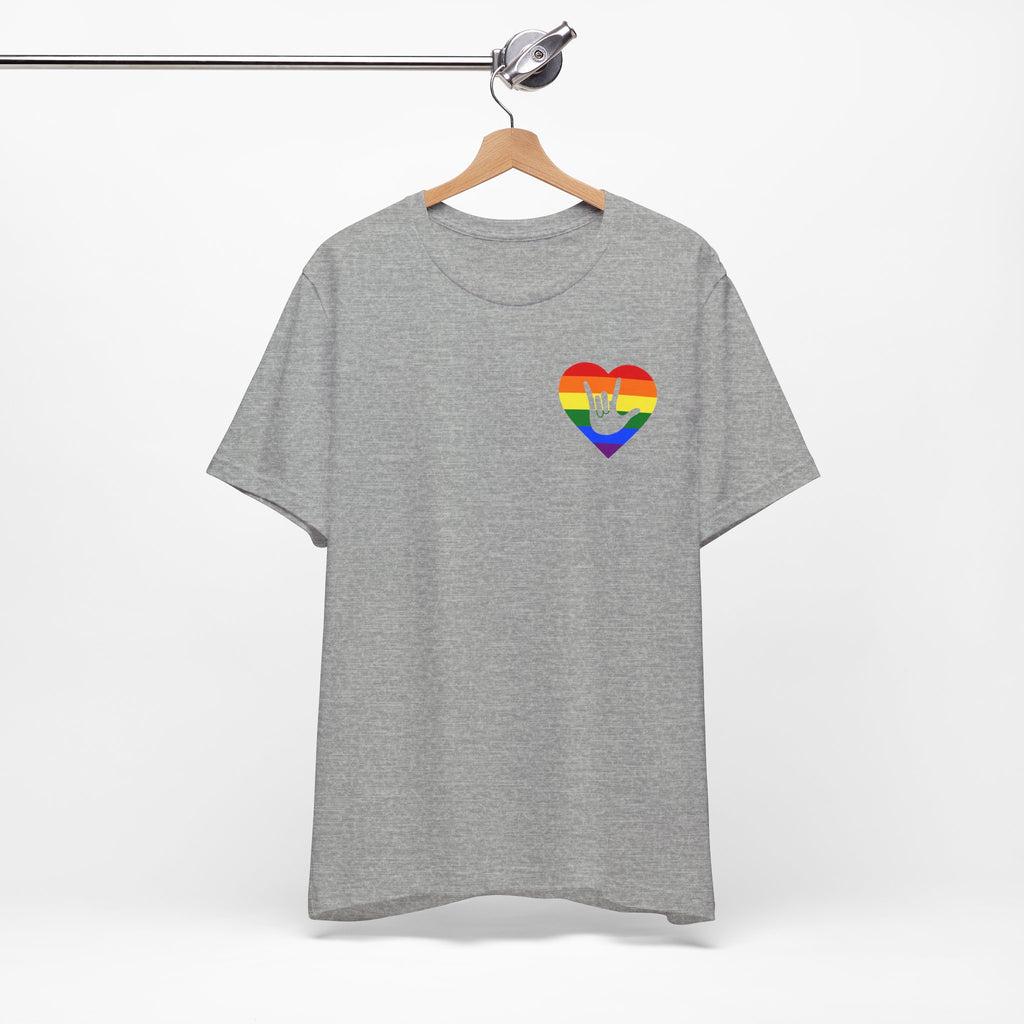 Front view of a athletic heather T-Shirt showing a pride coloured heart and the iconic ASL I Love You sign embedded in it on the left side of the chest, on a hanger against a white background