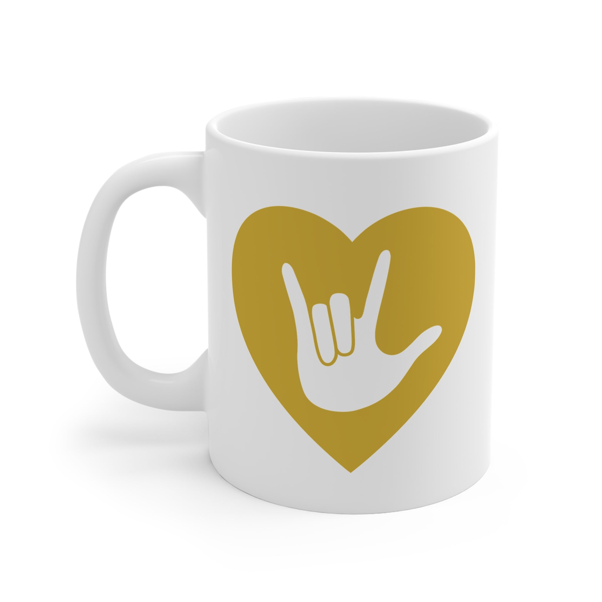 White mug with a gold coloured heart design featuring the ASL sign for I Love You embedded in it. The mug handle is on the left hand side of the mug.