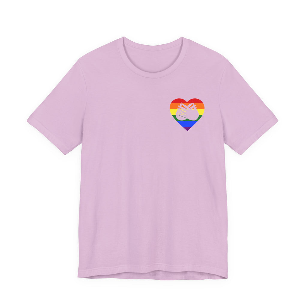 Front view of a lilac T-Shirt showing a pride coloured heart and the iconic BSL Love sign embedded in it on the left side of the chest