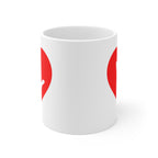 White mug with no handle visible, showing part of the red coloured heart design on each side.