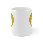 White mug with no handle visible, showing part of the gold coloured heart design on each side.