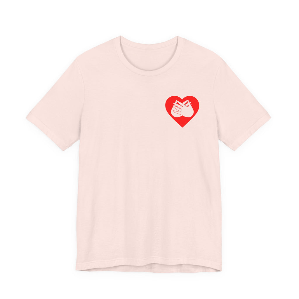 Front view of a soft pink T-Shirt showing a red coloured heart and the iconic BSL Love sign embedded in it on the left side of the chest