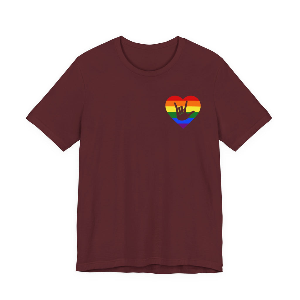 Front view of a maroon T-Shirt showing a pride coloured heart and the iconic ASL I Love You sign embedded in it on the left side of the chest