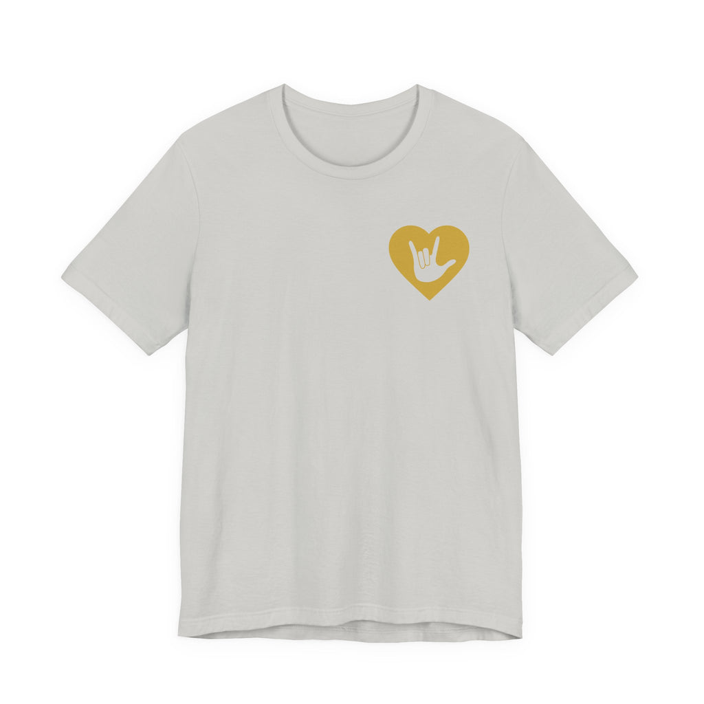 Front view of a silver T-Shirt showing a gold coloured heart and the iconic ASL I Love You sign embedded in it on the left side of the chest