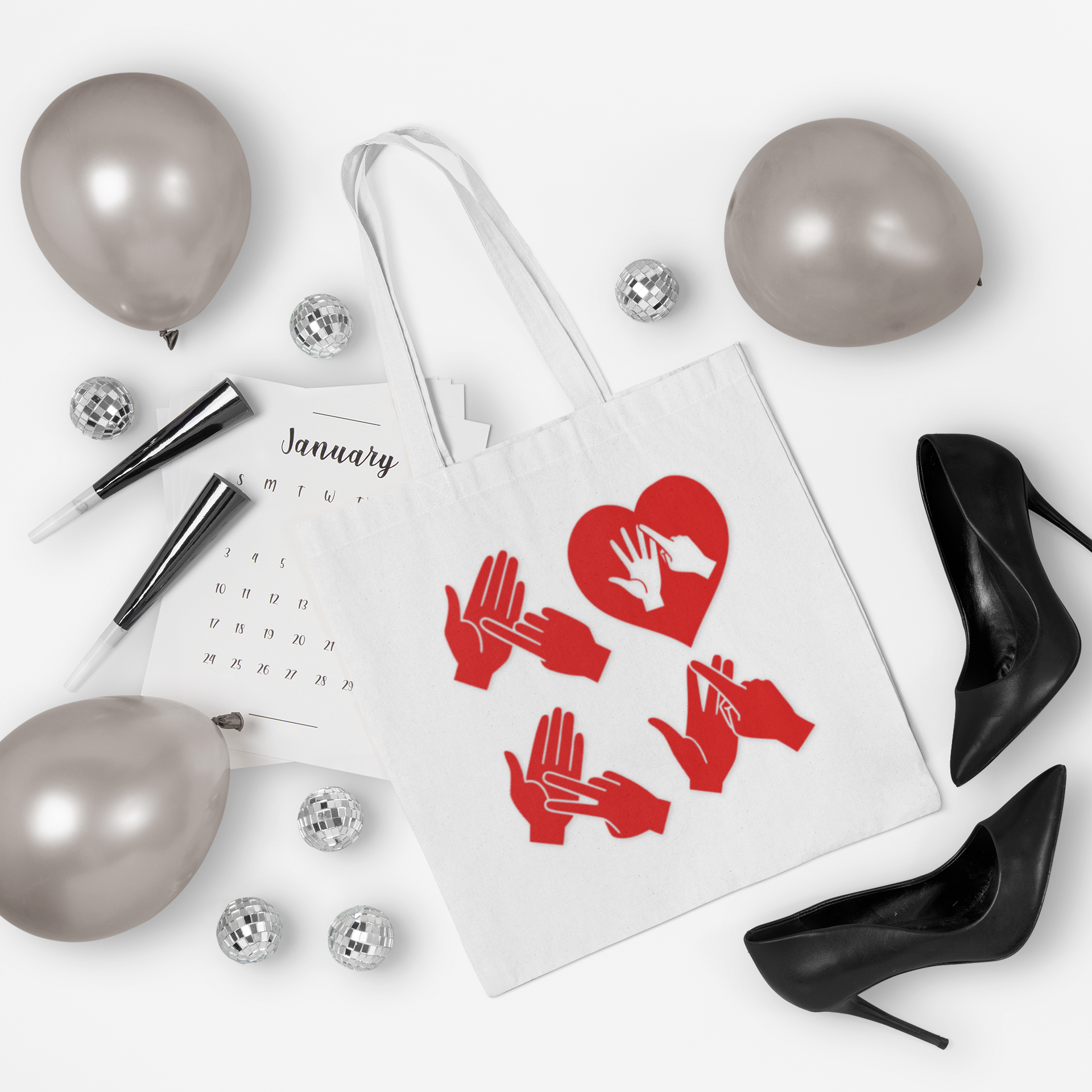 White Tote Bag with the word Love in red BSL Fingerspelling with the 'O' embedded in a heart shape, surrounded by black high heels, and balloons on a white background