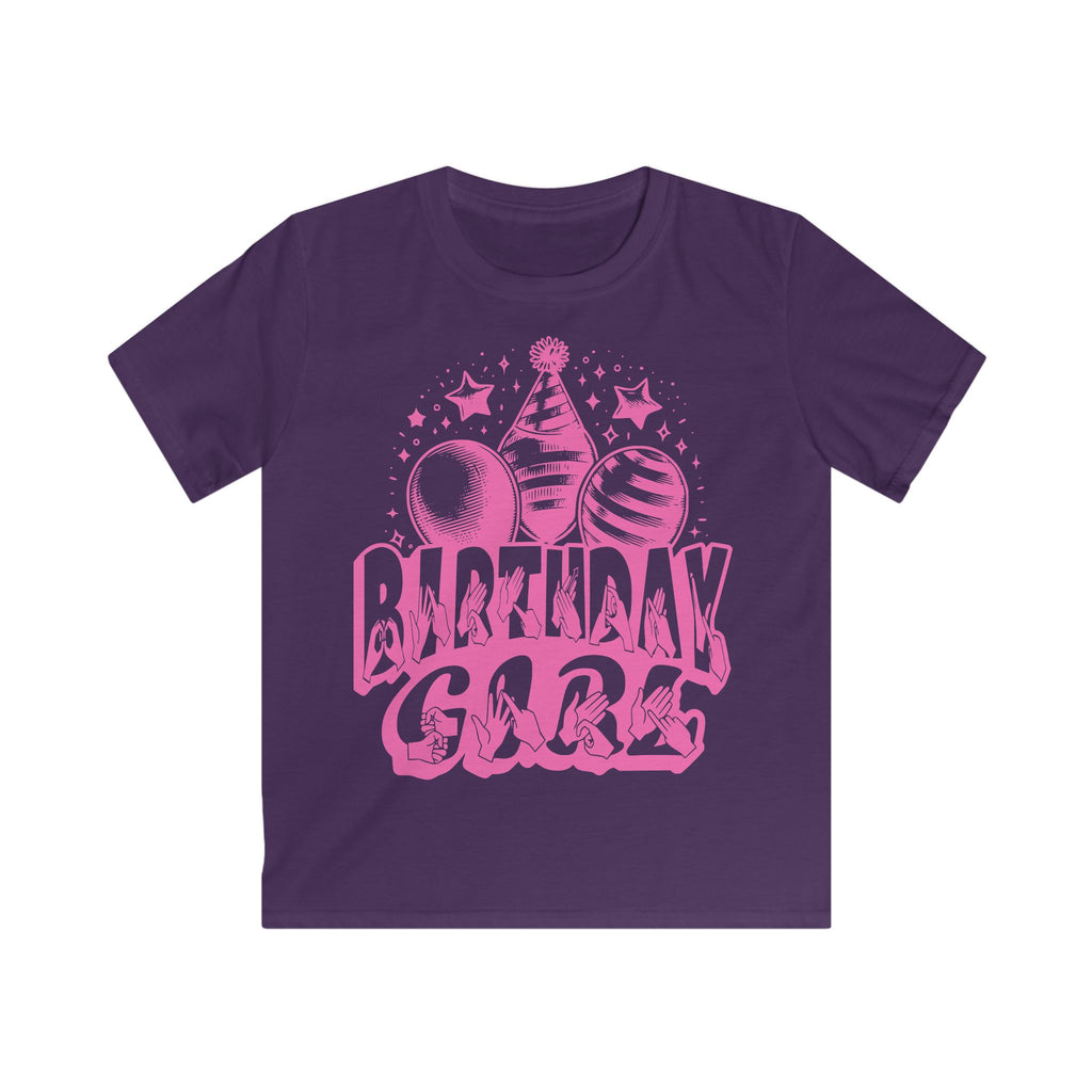 Purple kids' t-shirt with "Birthday Girl" in bold letters featuring British Sign Language fingerspelling, with pink balloons, stars, and a party hat above.