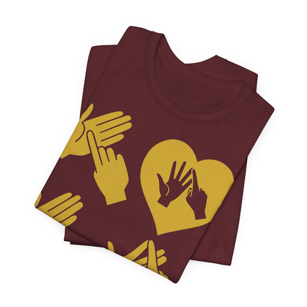 Folded maroon T-Shirt with the word Love in gold BSL Fingerspelling with the 'O' embedded in a heart shape