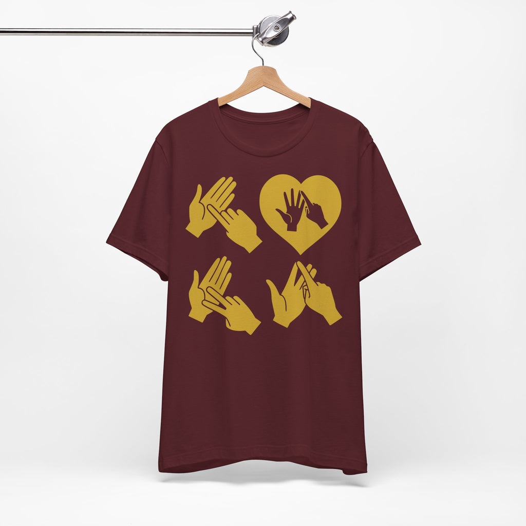 Front view of a maroon T-Shirt with the word Love in gold BSL Fingerspelling with the 'O' embedded in a heart shape, on a hanger against a white background