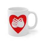 White mug with a red coloured heart design featuring the BSL sign for Love embedded in it. The mug handle is on the right hand side of the mug.
