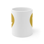 White mug with no handle visible, showing part of the gold coloured heart design on each side.
