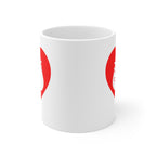White mug with no handle visible, showing part of the red coloured heart design on each side.