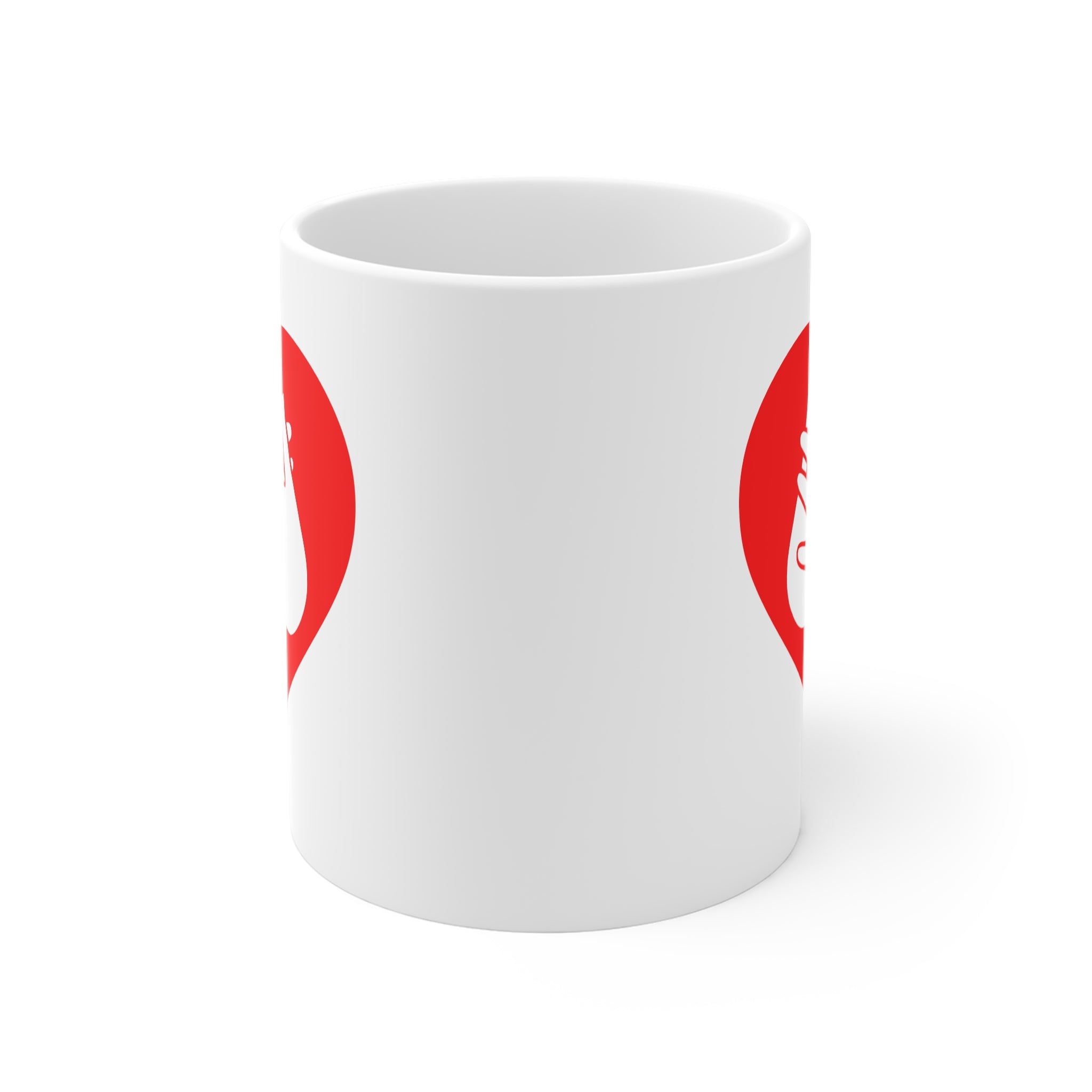 White mug with no handle visible, showing part of the red coloured heart design on each side.
