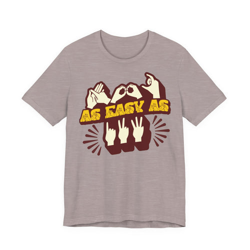 Front view of a heather pink gravel t-shirt with the phrase ABC As Easy As 123 in Fingerspelling & Text