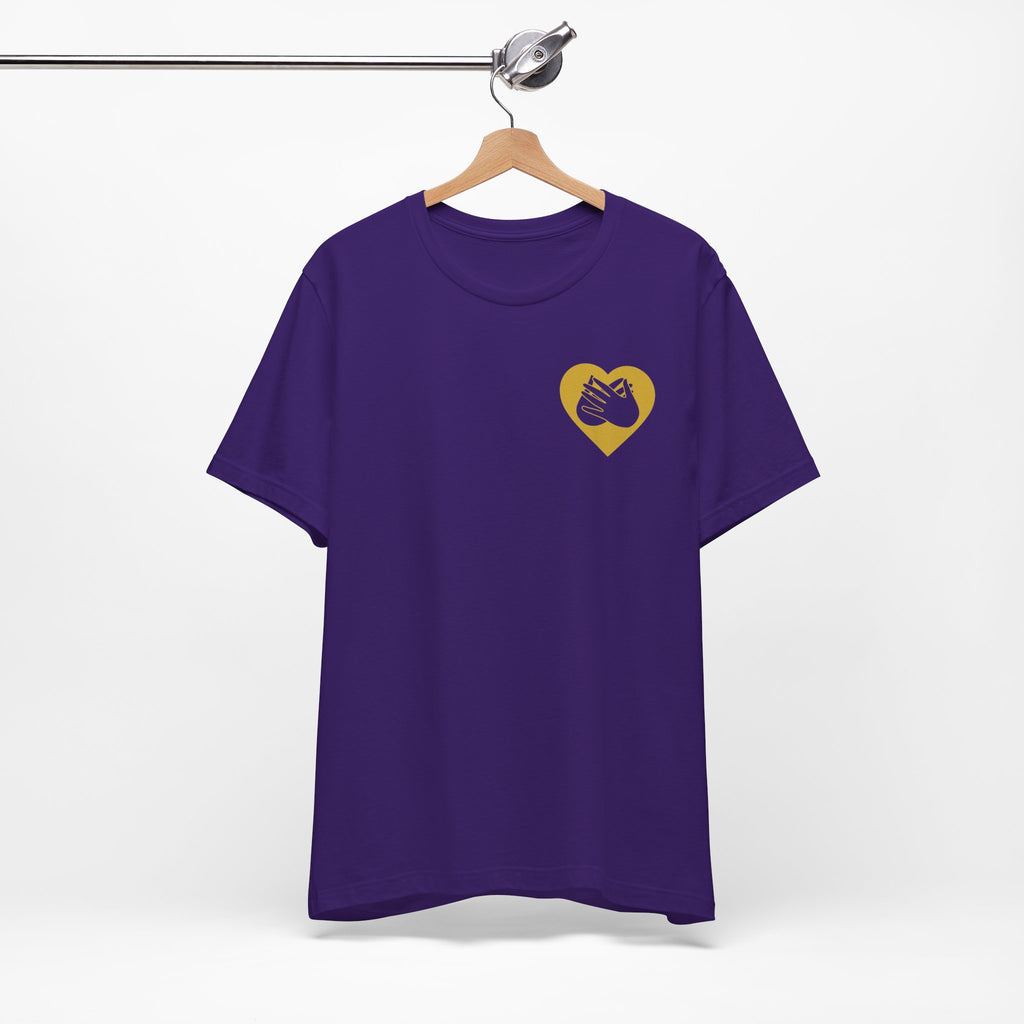 Front view of a team purple T-Shirt showing a gold coloured heart and the iconic BSL Love sign embedded in it on the left side of the chest, on a hanger against a white background