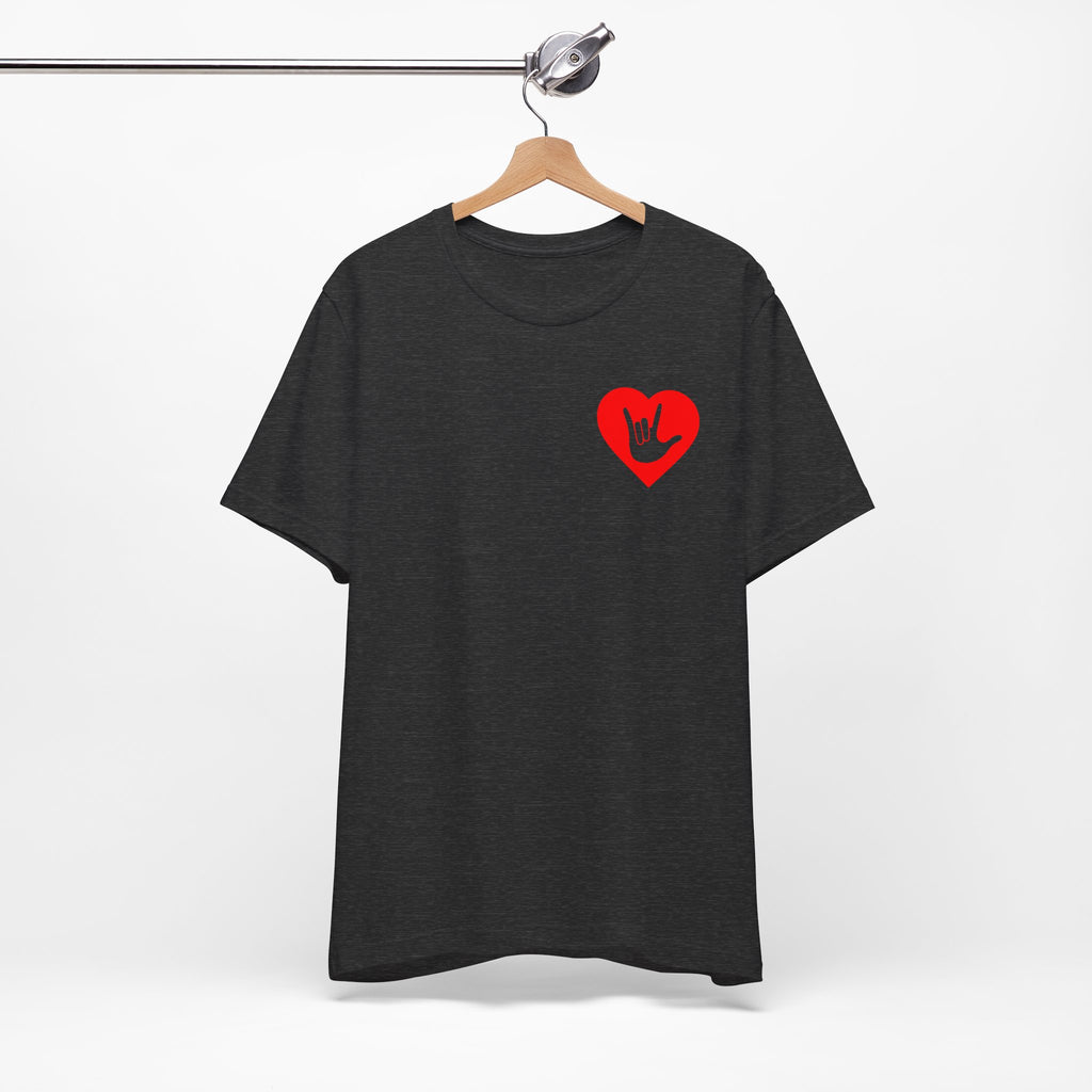 Front view of a dark grey heather T-Shirt showing a red coloured heart and the iconic ASL I Love You sign embedded in it on the left side of the chest, on a hanger against a white background