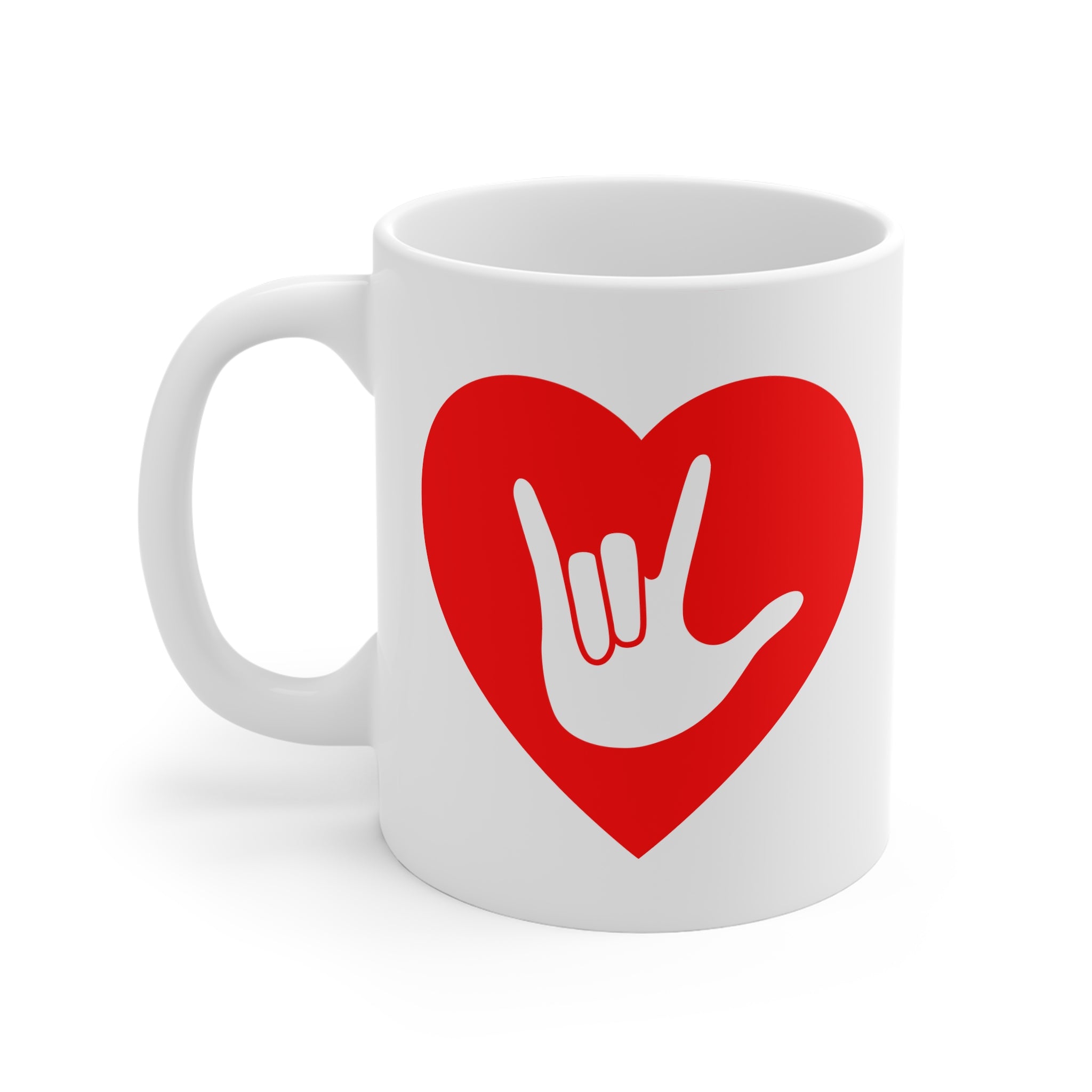 White mug with a red coloured heart design featuring the ASL sign for I Love You embedded in it. The mug handle is on the left hand side of the mug.