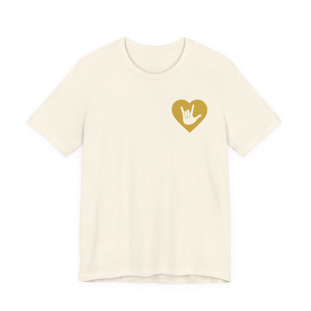 Front view of a natural T-Shirt showing a gold coloured heart and the iconic ASL I Love You sign embedded in it on the left side of the chest