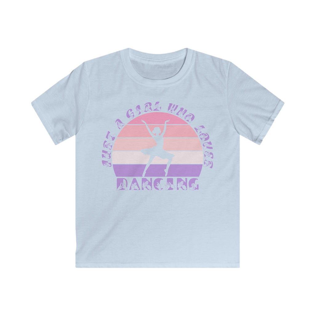 Light blue t-shirt with the phrase "Just a Girl Who Loves Dancing" above a colourful retro sunset and a silhouette of a girl dancing in the centre