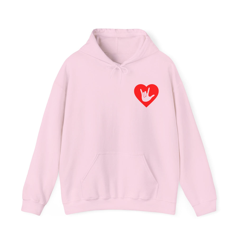 Front view of a light pink hoodie showing a red coloured heart and the iconic ASL I Love You sign embedded in it on the left side of the chest