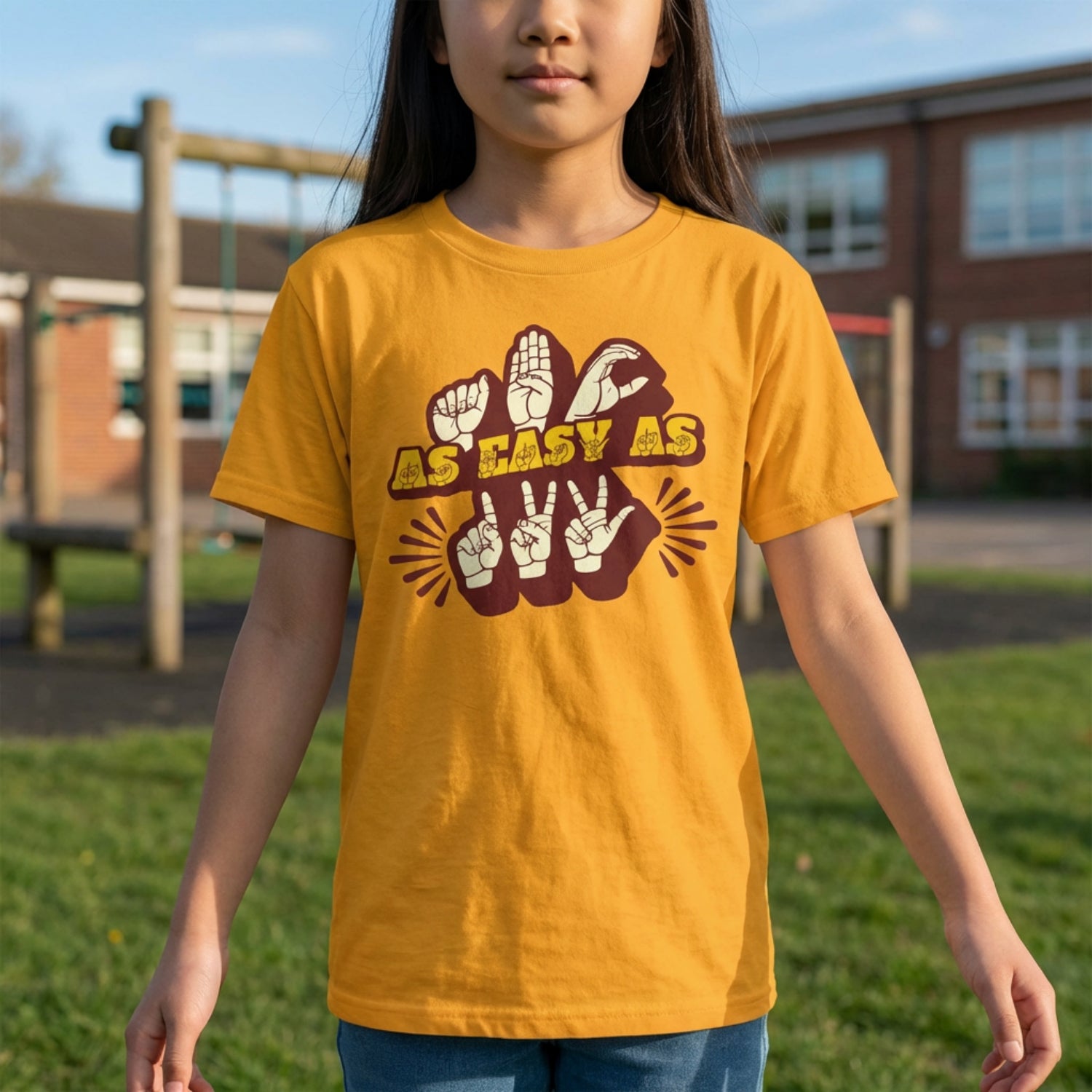 Person wearing a yellow t-shirt with a graphic design outdoors