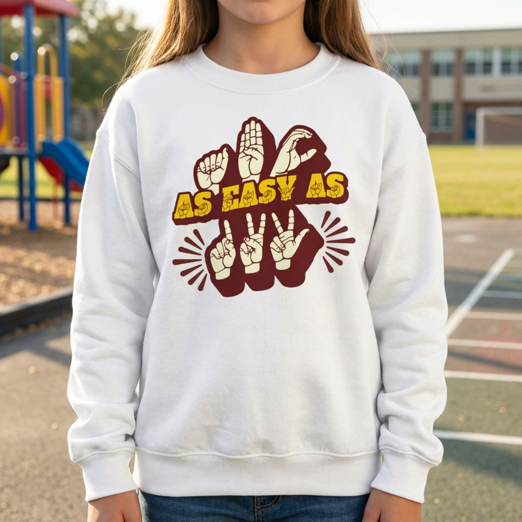 Person wearing a white sweatshirt with a graphic design on a playground background