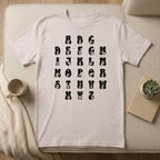 Front view of a ice grey t-shirt with ASL Alphabet - Black Fingerspelling & Text positioned on furniture.