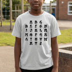 Child wearing a white t-shirt with black alphabet letters outdoors.