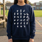 Person wearing a navy blue sweatshirt with white hand signs on a playground background
