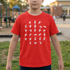 Child wearing a red t-shirt with white graphics in an outdoor setting