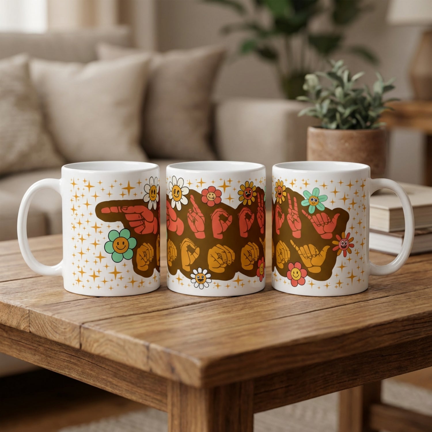 Three mugs with colorful designs on a wooden table in a cozy living room setting.