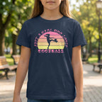 Person wearing a navy blue t-shirt with a colorful graphic and text in an outdoor setting