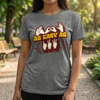Person wearing a gray t-shirt with a graphic design and text in an outdoor setting