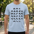 Person wearing a light blue t-shirt with black fingerspelling design in an outdoor setting.