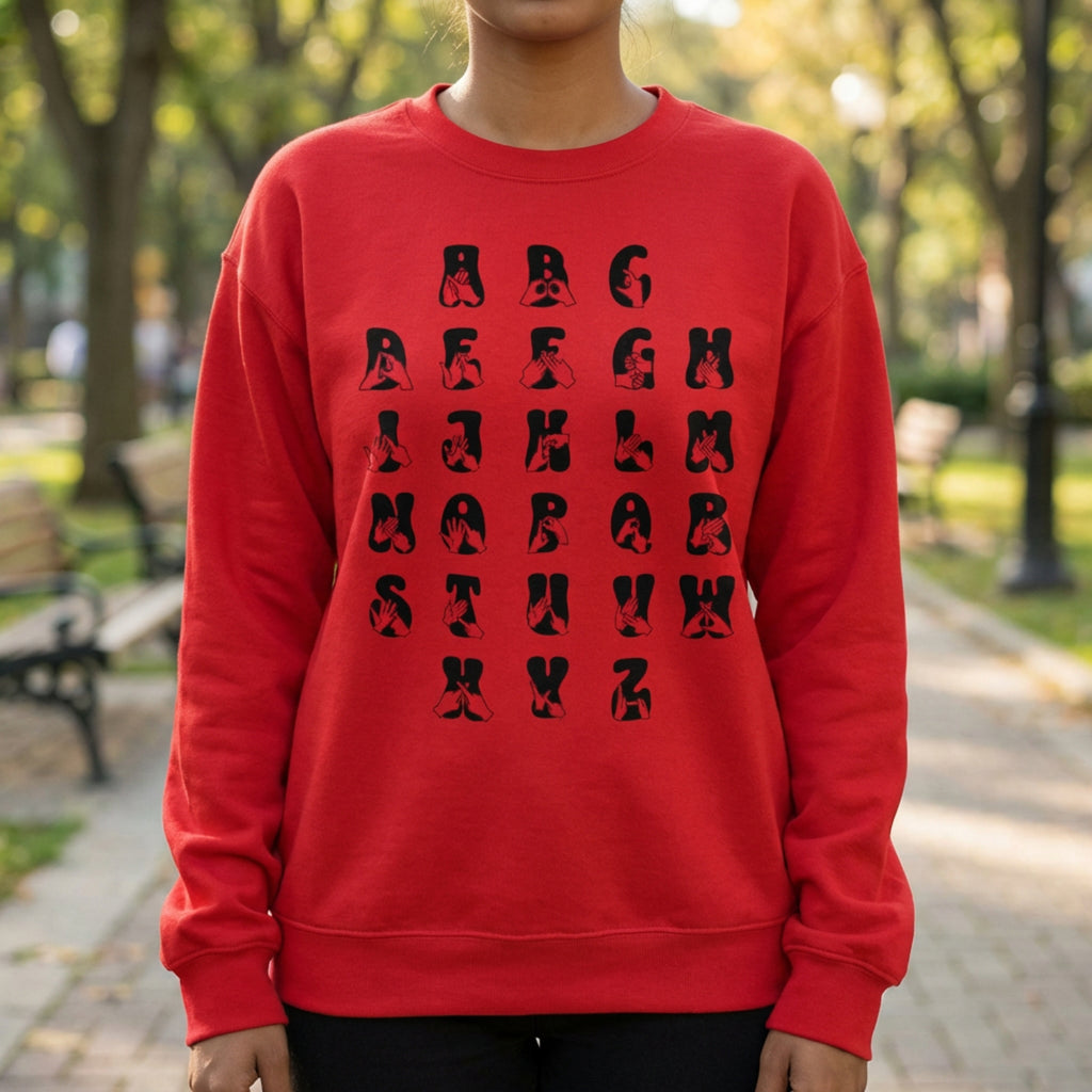Person wearing a red sweatshirt with black alphabet design in an outdoor setting