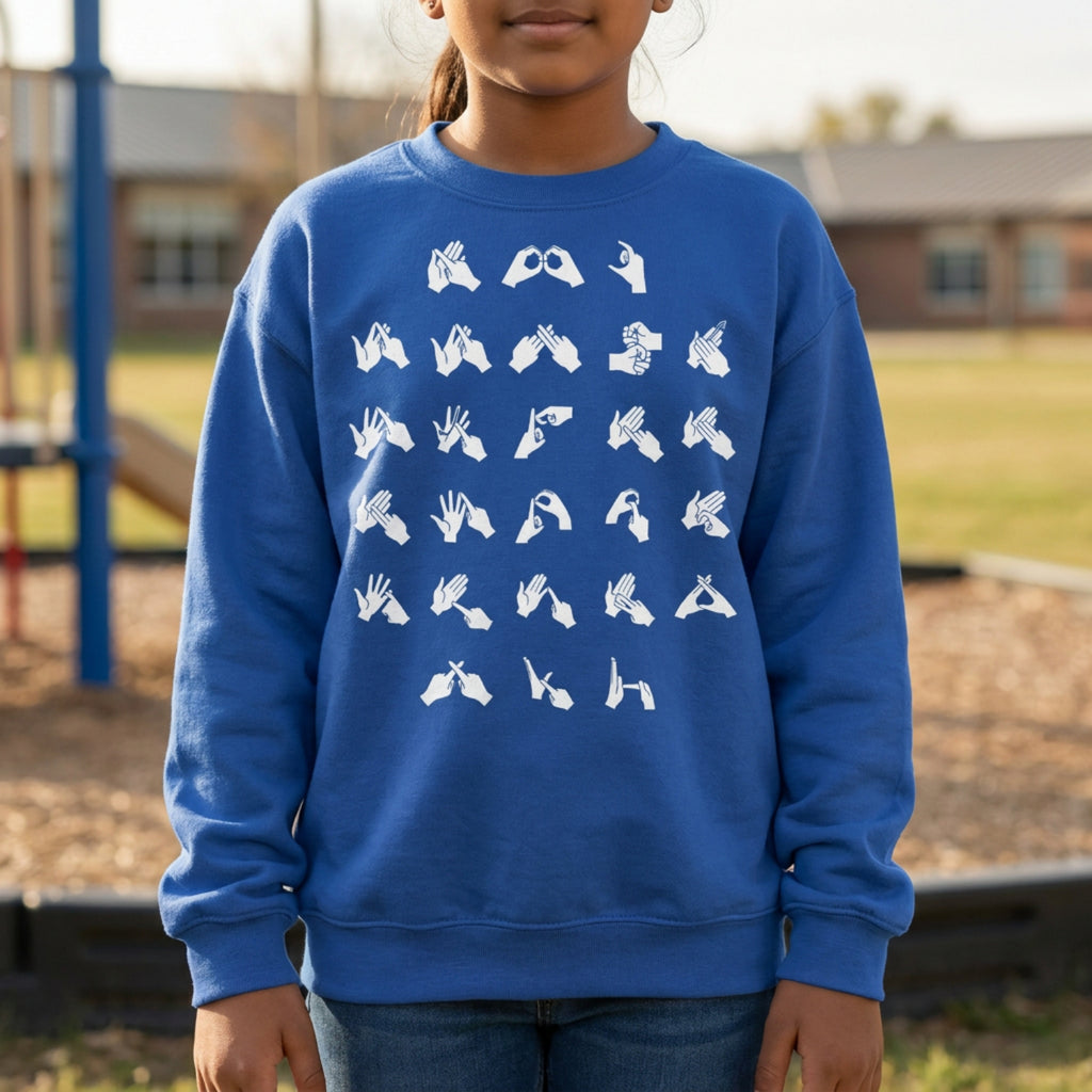 Person wearing a blue sweatshirt with white fingerspelling design on a playground background