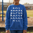 Person wearing a blue sweatshirt with white fingerspelling design on a playground background