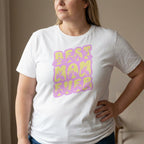 Person wearing a white t-shirt with 'BEST MOM EVER' in purple and yellow.